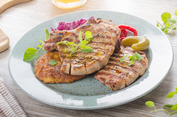 Grilled pork chops with herbs and garlic, potato pancakes