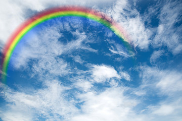 Rainbow and White clouds in blue sky background