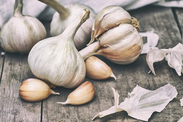 Garlic head and cloves on grey rustic wooden background