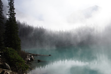 Fototapety  Morning mist rising from  turquoise lake