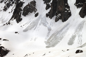 Snow mountain with traces from avalanche in spring day
