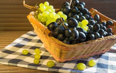  Green and black grapes with leaves, rustic style, black backgrou