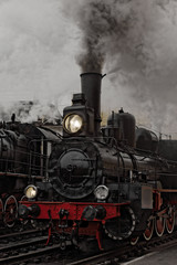 Fototapeta na wymiar Old steam locomotive. Low key photo. Vintage style.