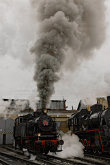 Obraz na płótnie Canvas Old steam soviet locomotive. Low key photo. Vintage style. Red star and lettering USSR.