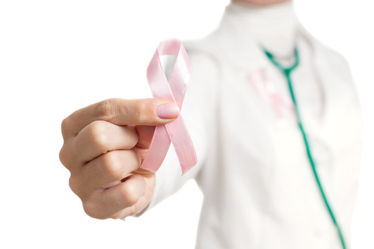 Medic with pink ribbon on her chest holding pink ribbon isolated on white. Pink ribbon. Symbol of breast cancer awareness. National Breast Cancer Awareness Month. Mammography Day.
