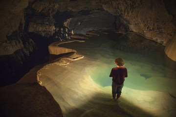 A Filipino Tour Guide Holds A Lantern Inside Sumaging Cave Or Big Cave; Sagada, Luzon, Philippines