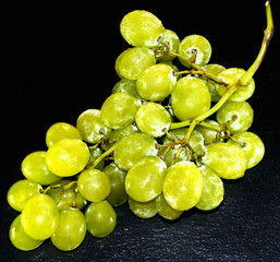 Bunch of grapes on a black slate stone