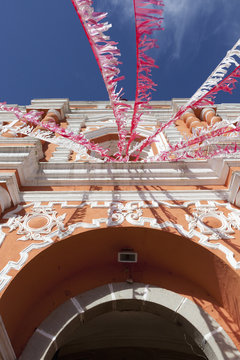 Red And White Streamers Hung Over An Arched Doorway; Guatemala City, Guatemala
