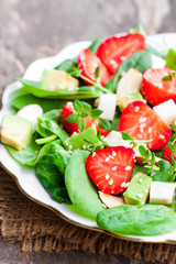 Spring  salad with spinach leaves and strawberries and feta chee