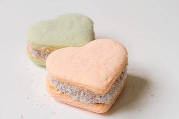 Two color alfajores cornstarch with heart shape on white backgro