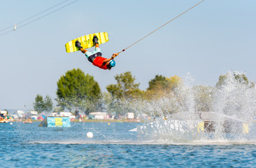 Young active man on the wakeboard in cable park (extreme water sport), Nove Mlyny, South Moravia, Czech Republic