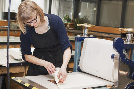 Young Female Art Student Creating Prints In Studio; Edmonton, Alberta, Canada