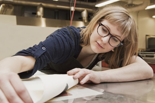Young Female Art Student Creating Prints In Studio; Edmonton, Alberta, Canada