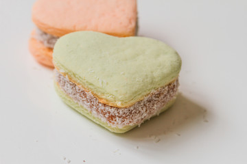 Two color alfajores cornstarch with heart shape on white backgro