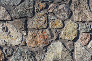 Textures stone background old wall made of pieces of granite