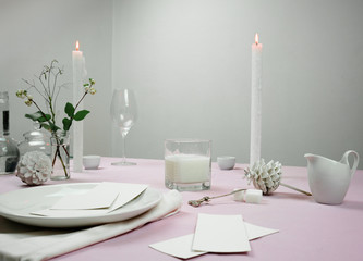 elegant table setting. tablecloth, milk , flowers in a vase, candle