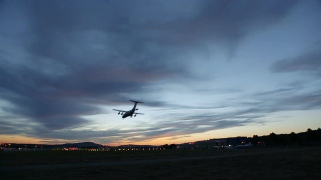 Airplane landing at Airport at sunset