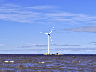 Offshore wind turbine on a small island. Renewable energy sources.