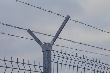 Steel fence with barbed wire