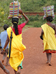 Tribal women carry goods  on their heads
