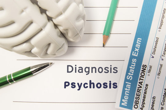 Diagnosis Psychosis. Figure of human brain, result of mental status exam, pen and pencil surrounded written psychiatric diagnosis Psychosis in medical report on doctors deck. Concept for psychiatry
