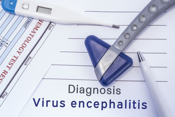 Diagnosis virus encephalitis. Paper medical report written with neurological diagnosis of virus encephalitis is surrounded by a neurological reflex hammer, electronic thermometer and common blood test