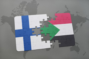 puzzle with the national flag of finland and sudan on a world map background.