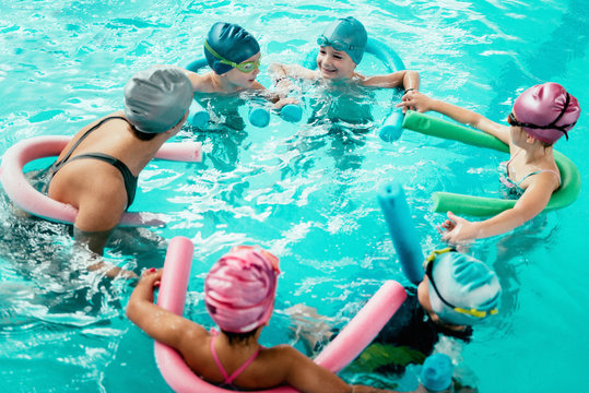 Kids having fun in swimming school
