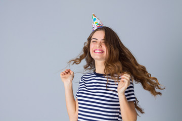 Woman in celebration cap whirling