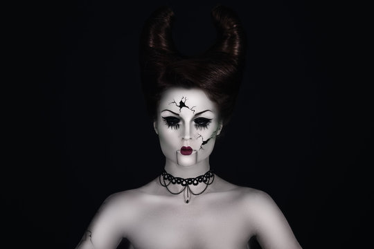 Talking broken doll with horns on her head