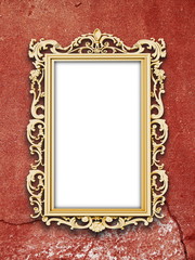 Single blank golden Baroque picture frame on red cracked concrete wall background