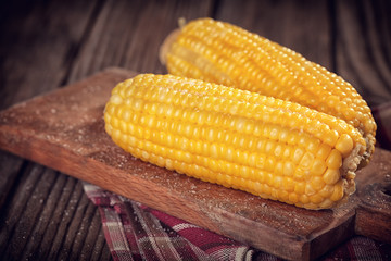 Corn cobs on rustic table