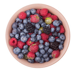 Brown ceramic plate with berries isolated on the white background with clipping path