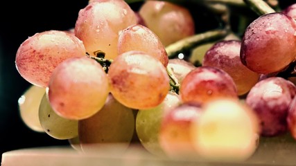 Mix color grape bunch, bleached colors, dark background