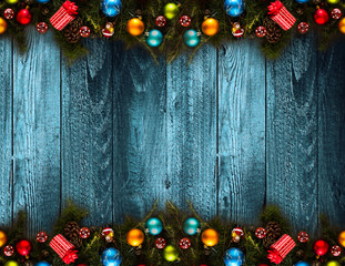 2017 Happy New Year seasonal background with real wood green pine, colorful Christmas baubles, gift boxe and other seasonal stuff over an old wooden aged background