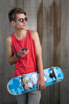 Teenage skater boy using smartphone wifi connected. Teenager por