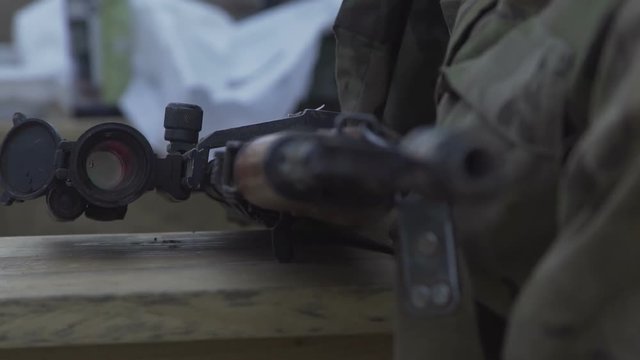 Military uniforms in small arms. Rifle and machine gun