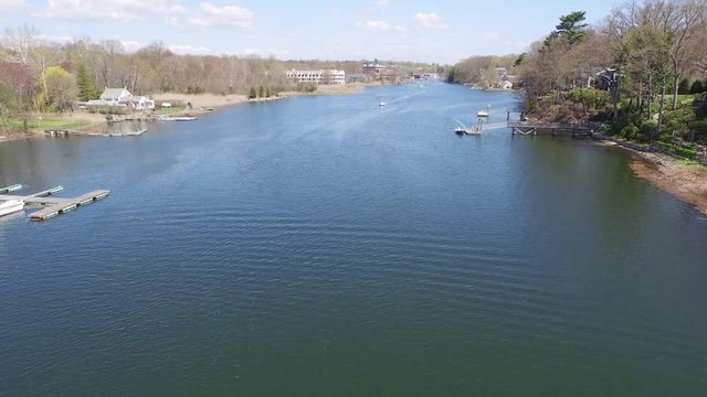 Wide aerial over a river during the day, Saugatuck River.