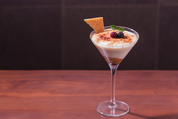 tiramisu in glass cup with dark background