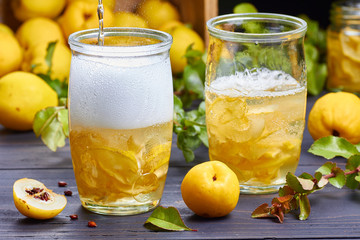 carbonated drink with syrup of japanese quince on fresh  fruits background