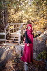 A pregnant muslim woman with natural background during autumn season