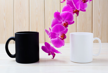 White and black mug mockup with pink orchid