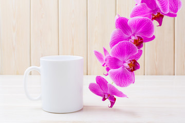 White coffee mug mockup with pink orchid