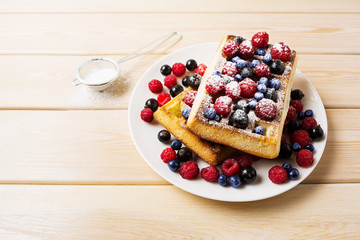 Belgian waffles with blueberry, raspberry and ising sugar
