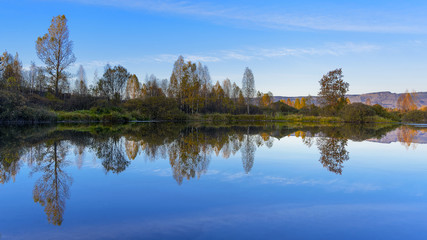 River landscape with multicolored fall trees