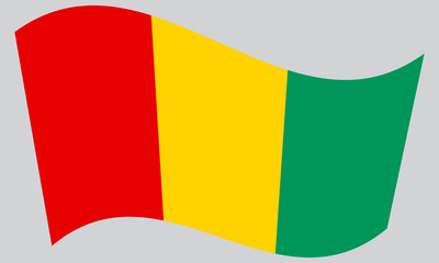 Flag of Guinea waving on gray background