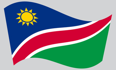 Fototapeta premium Flag of Namibia waving on gray background