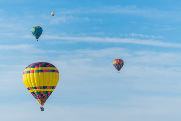 Fototapeta premium This is a photo of a beautiful hot air balloon slowly sailing through a calm blue sky.