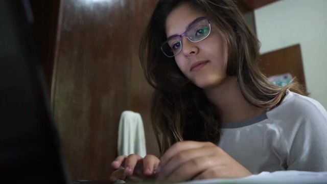 Young Brazilian woman on laptop computer.