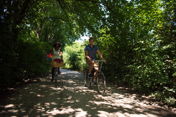 Naklejka premium Young multiethnic couple having a bike ride in nature